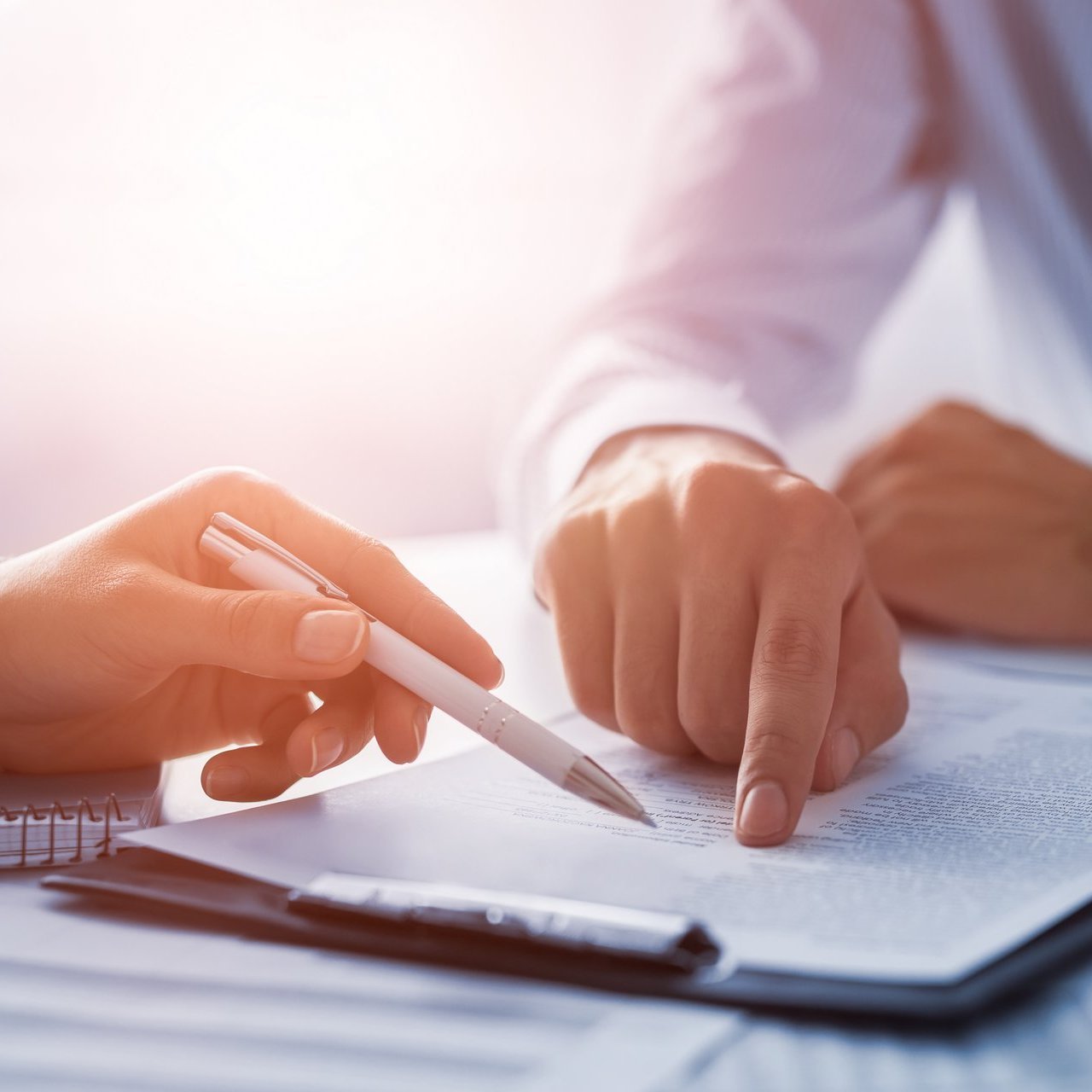 Business people negotiating a contract.